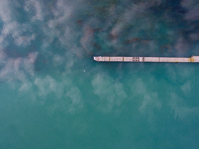 Aerial view of a wooden pier on turquoise water