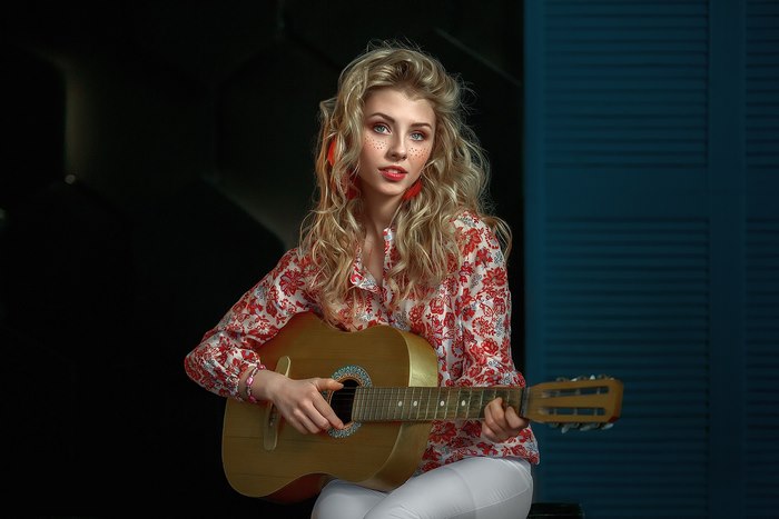 Blonde woman playing guitar