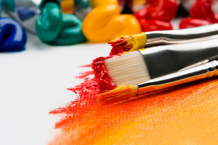 Close-up of Paintbrushes with Vibrant Red and Orange Paint