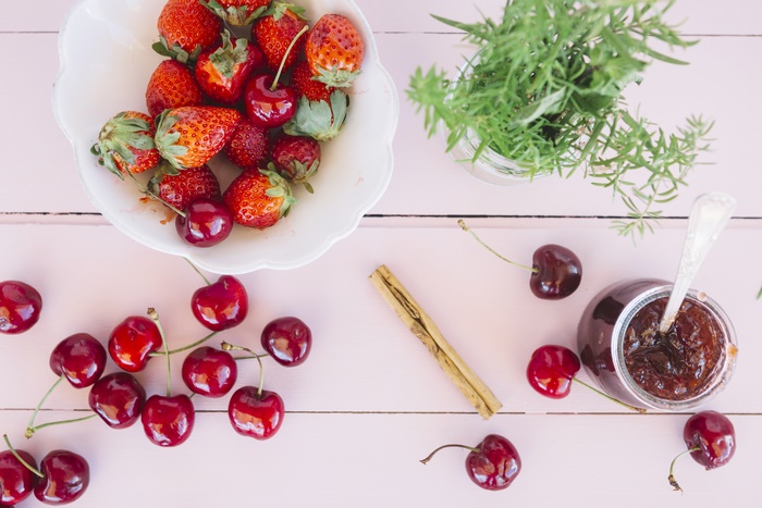 Strawberries and cherries with jam and cinnamon