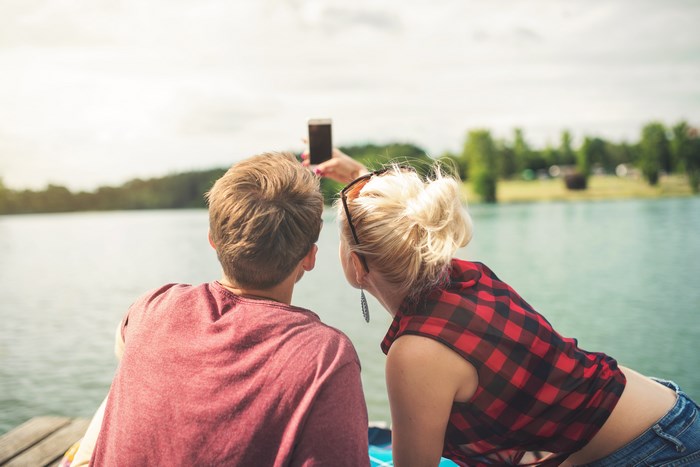 Couple taking a selfie by the lake
