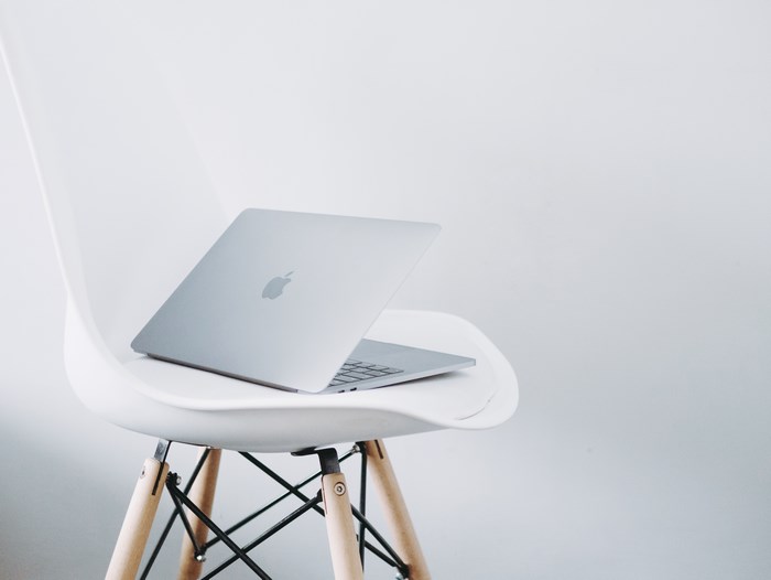 Silver Apple MacBook on a White Chair