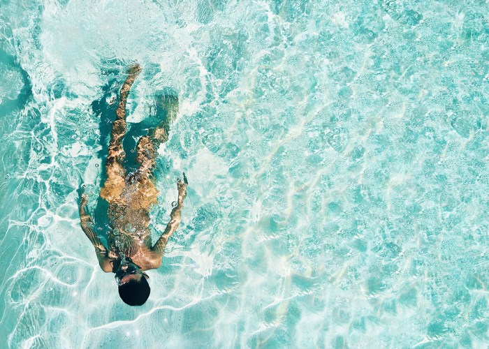 Boy swimming underwater in a pool