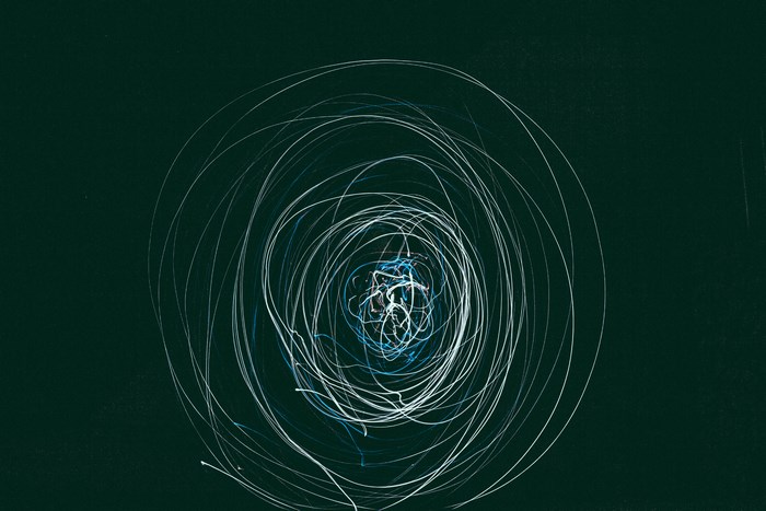Abstract light painting with blue and white lines on dark background