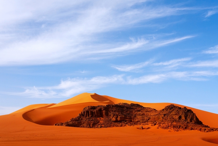 Sahara Desert Sand Dunes and Rocky Outcrop in Algeria