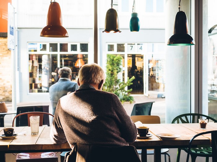 Two men sitting at a table in a cafe