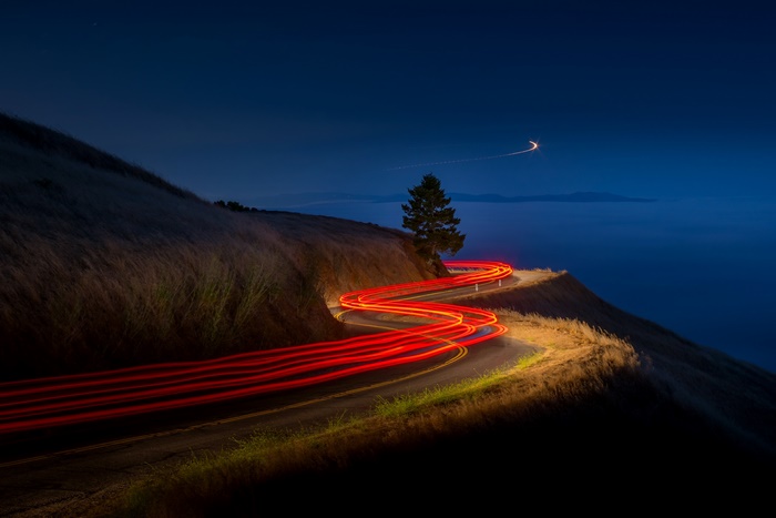 Light trails on a winding road at night