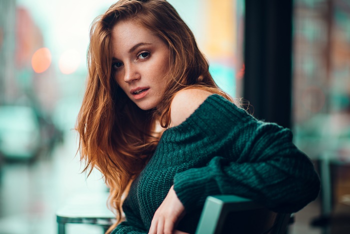 Redhead woman with long hair wearing a sweater
