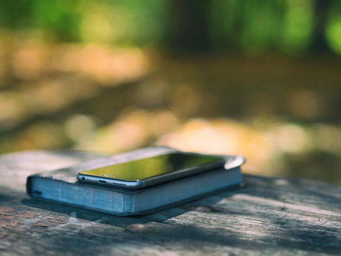 iPhone on a book on a wooden table