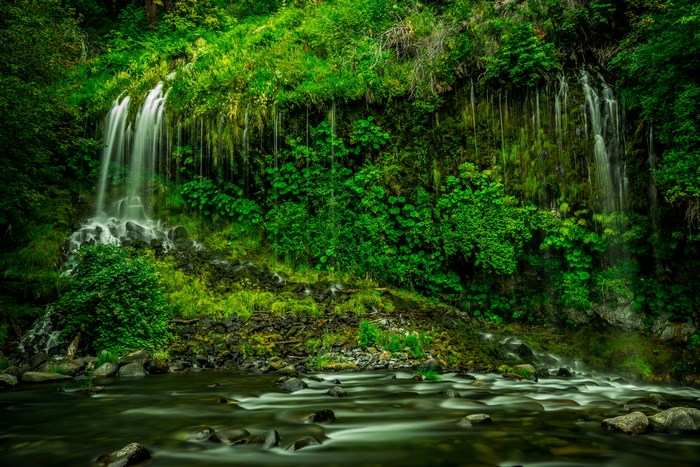 Waterfall cascading over mossy rocks into a stream
