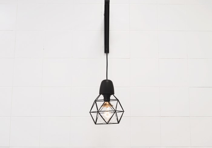 Black geometric hanging light fixture with bulb