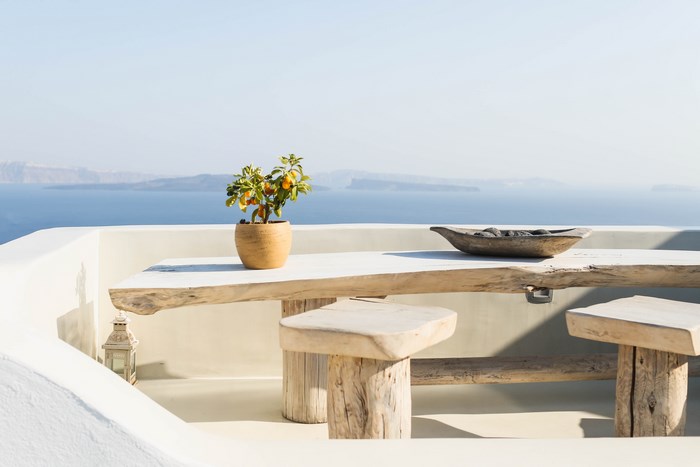 Outdoor table and seats with ocean view in Santorini