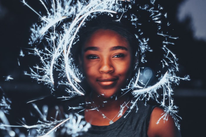 Woman with sparklers in long exposure photography