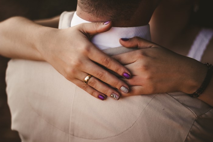 Couple embracing with wedding ring