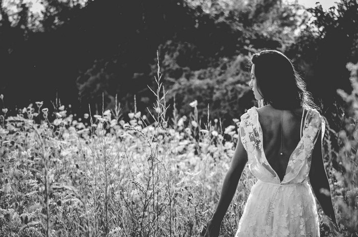 Woman in a lace dress in a meadow