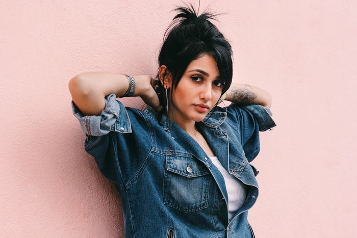 Woman in denim jacket with tattoo