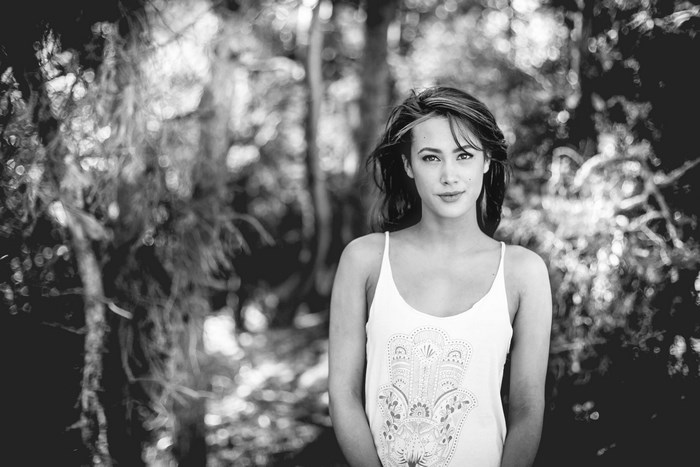 Woman in a white tank top in a forest