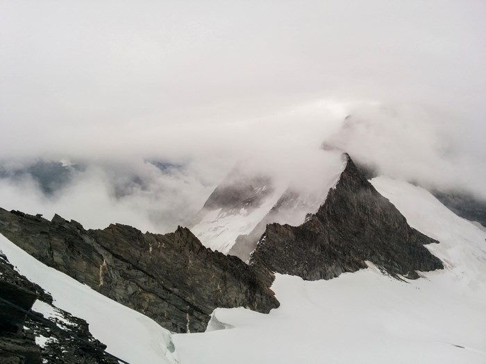 Snowy mountain peaks shrouded in clouds