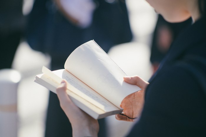 Person reading a book outdoors