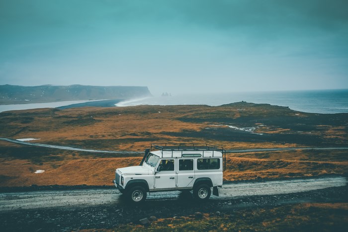 White Land Rover Defender on a dirt road in Iceland