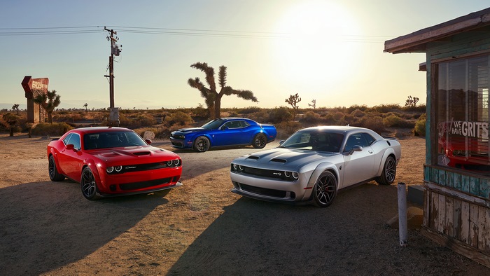 Three Dodge Challengers in a desert landscape