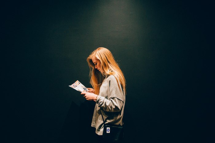 Woman reading a brochure in a museum