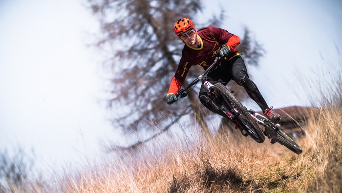 Mountain Biker Jumping on Autumn Trail
