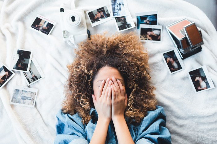 Woman with curly hair and polaroids