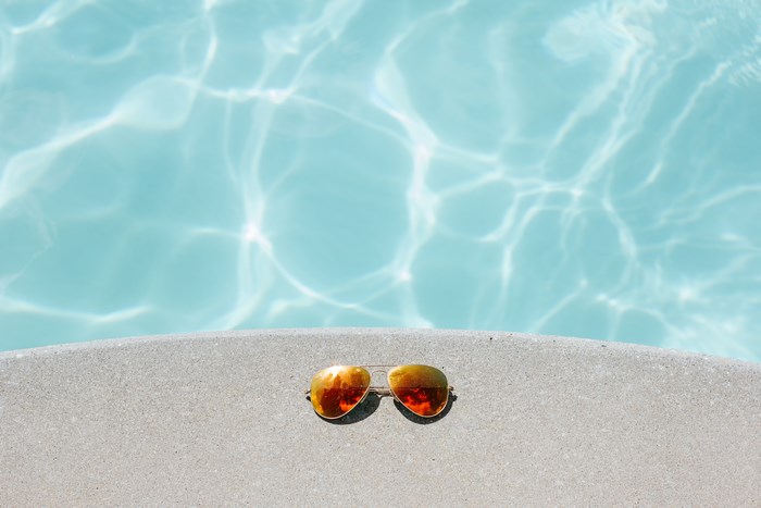 Sunglasses by a swimming pool