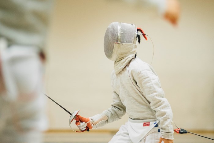Fencer in protective gear with sword