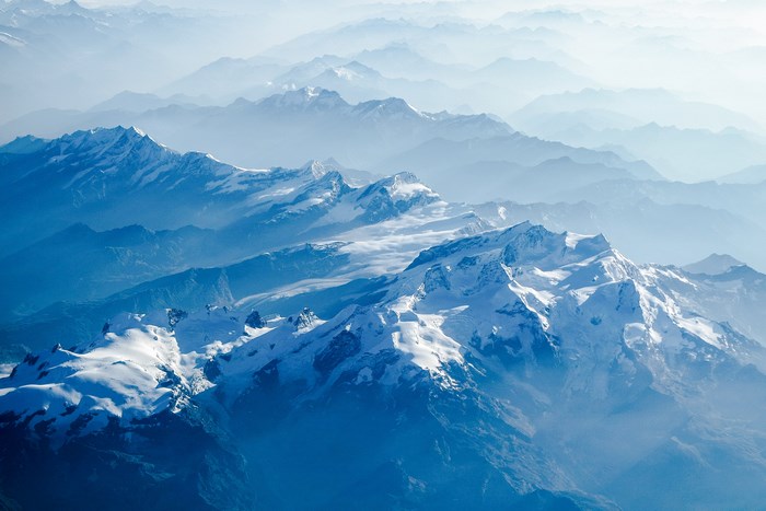 Snow-capped mountain range shrouded in mist