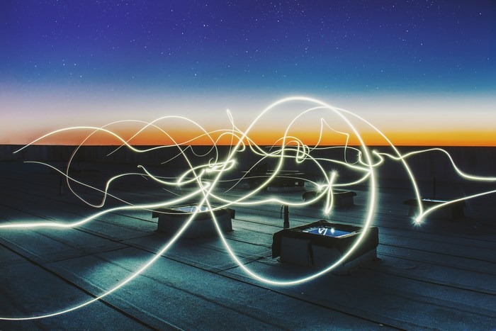 Light trails on a rooftop at sunset
