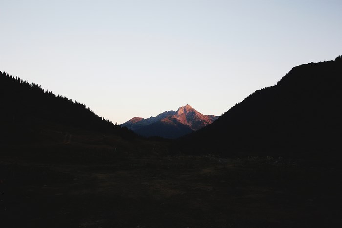Mountain range at sunset with dark foreground