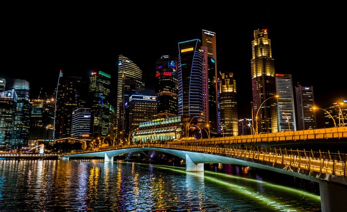 Singapore cityscape at night with illuminated skyscrapers and bridge