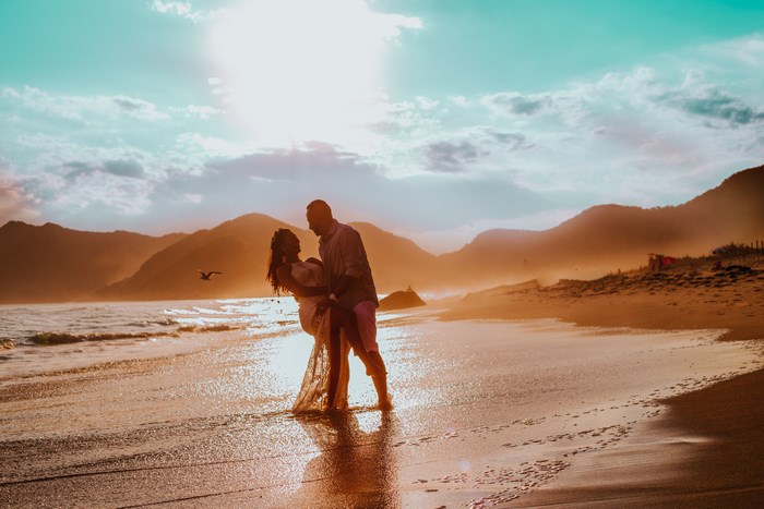 Couple embracing on a beach at sunset