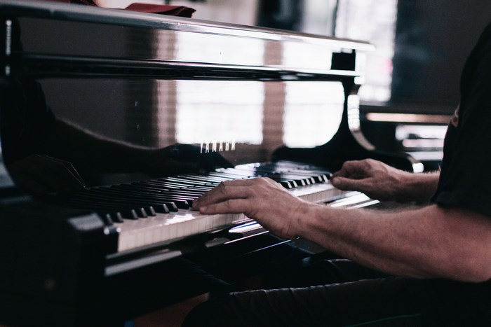 Yamaha piano with hands playing
