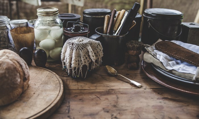 Vintage kitchen table with bread, eggs, and utensils