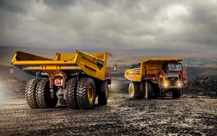 Two Volvo R60D dump trucks in a mine