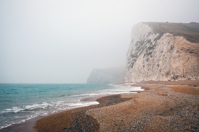 Misty Coastline with White Cliffs and Ocean