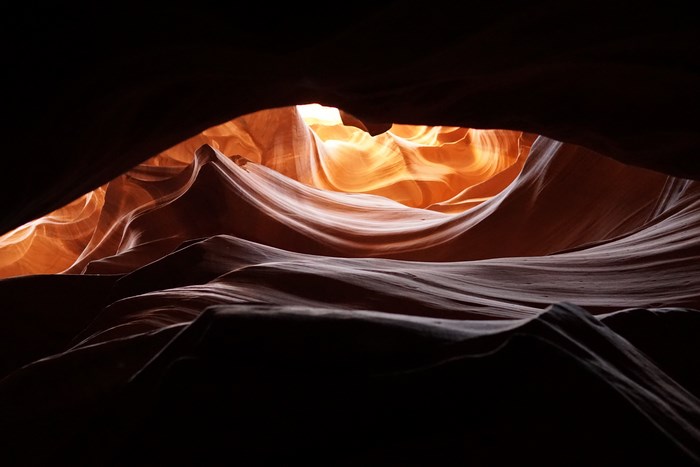 Sunlight illuminating the wavy rock formations of Antelope Canyon