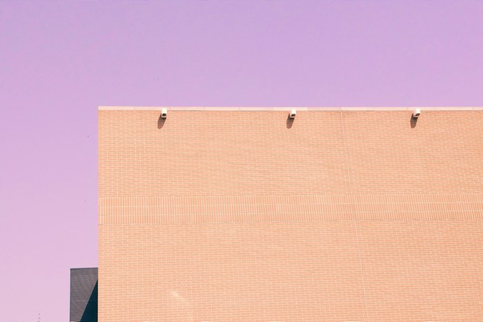 Minimalist Peach Brick Building Against Purple Sky