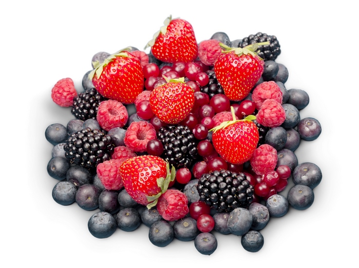 A pile of fresh berries including strawberries, blueberries, raspberries, and blackberries