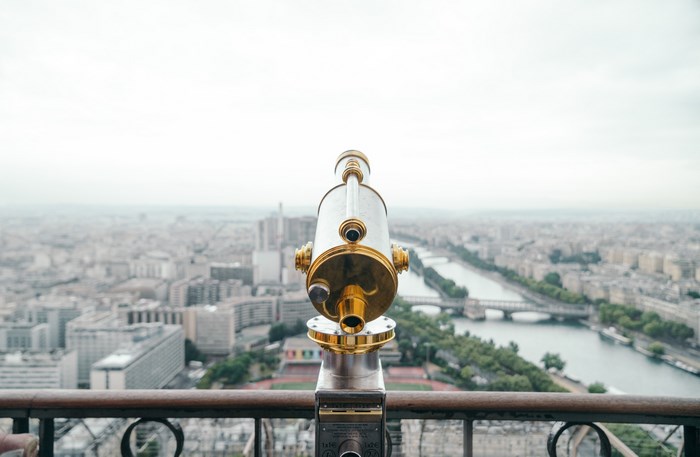 Telescope overlooking Paris cityscape and river