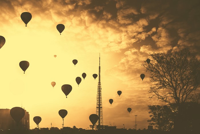 Hot air balloons flying over Brazil at sunset