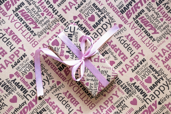 Birthday gift wrapped in patterned paper with ribbon