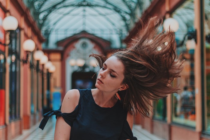 Woman with windblown hair in Paris passage