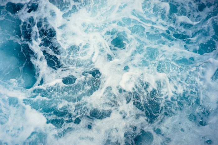 Turquoise ocean water with white foam