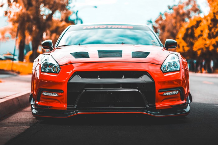 Red Nissan GT-R sports car with Toyo Tires banner
