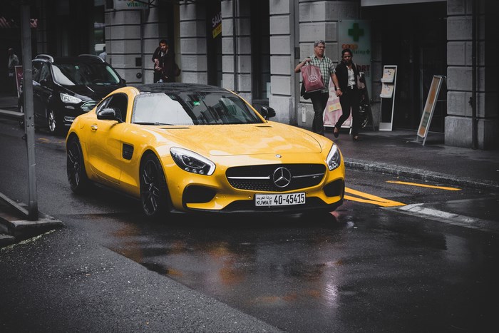Yellow Mercedes-AMG GT S on a Wet City Street