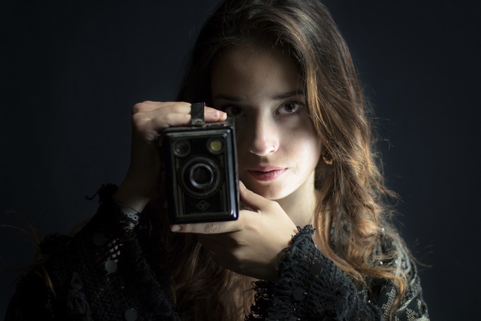 Woman holding a vintage camera
